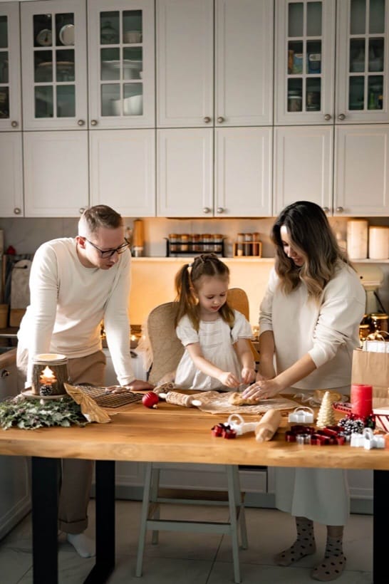 Family baking gingerbread in the kitchen — Christmas session at home