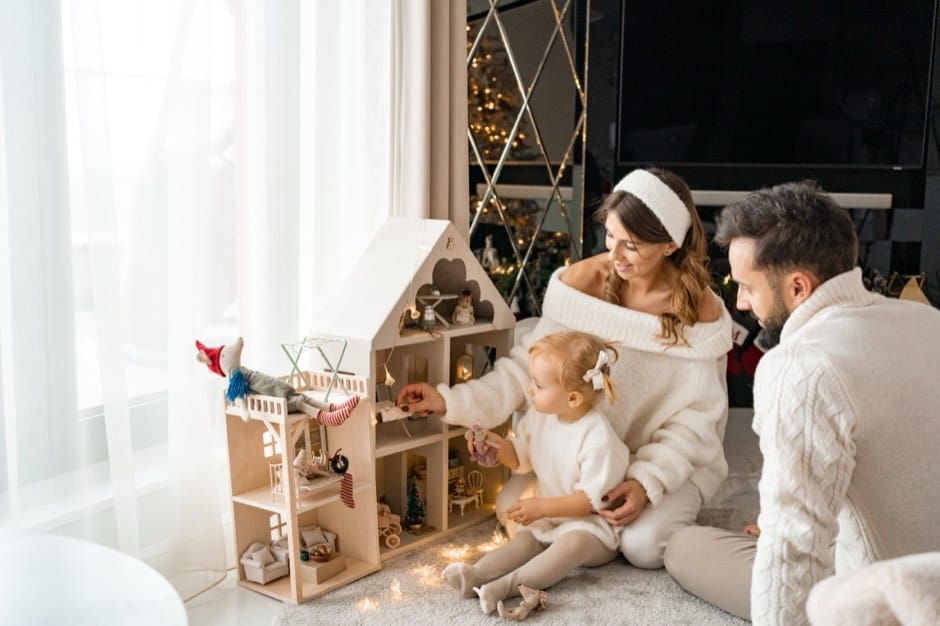 Family playing with a dollhouse — Christmas session at home