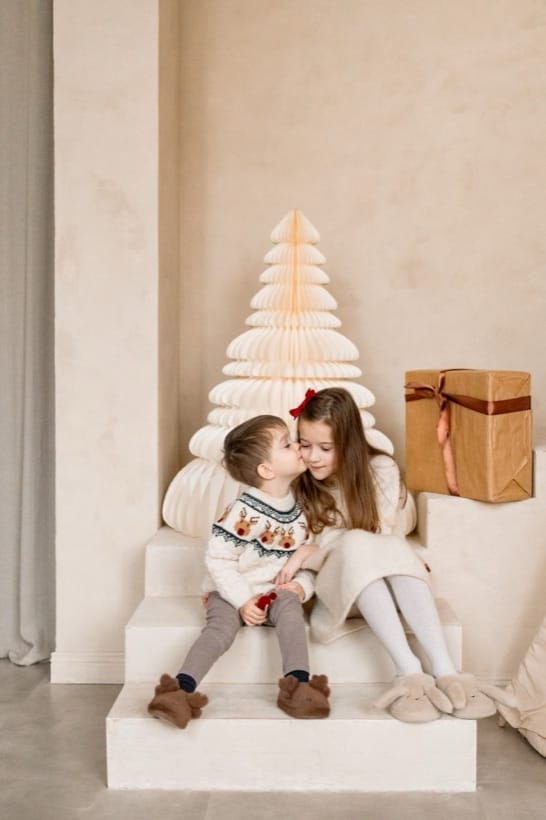 Siblings by the Christmas tree — studio session