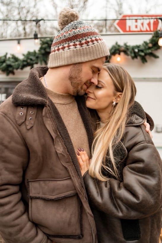 A couple at a Christmas session by the camper studio